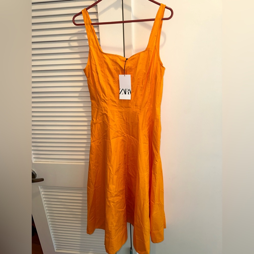 Pretty orange Zara dress size large new with tags. Zipper on side.